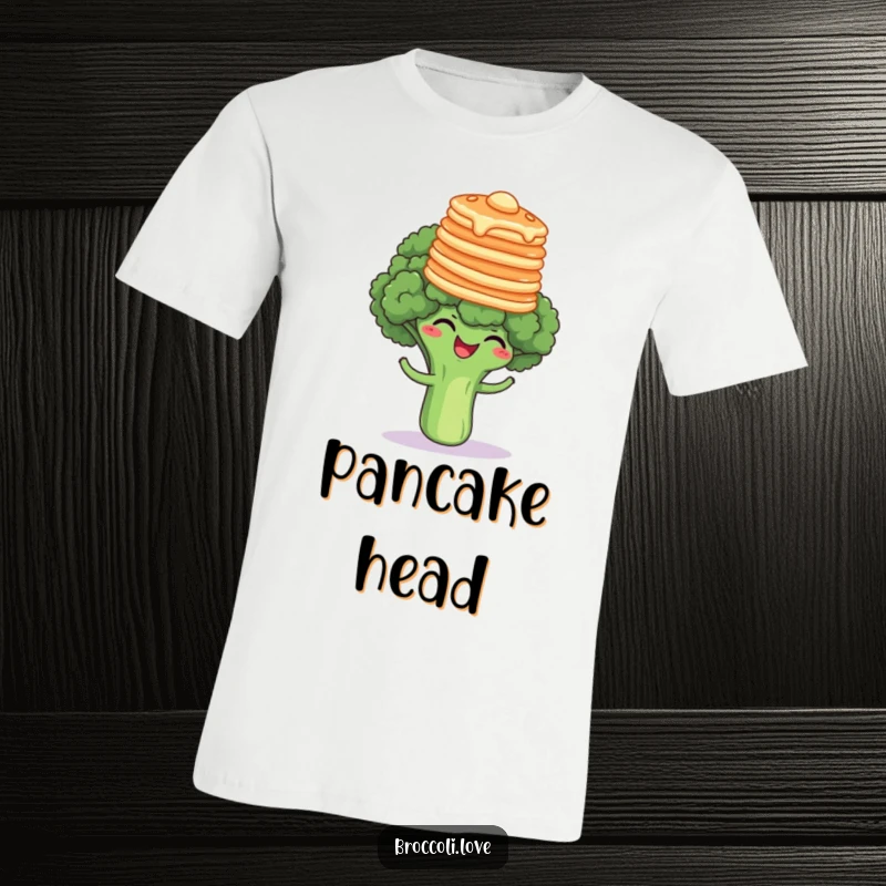 Funny broccoli floret giggling uncontrollably while balancing a precarious stack of pancakes on its head, a hilarious food-themed shirt.